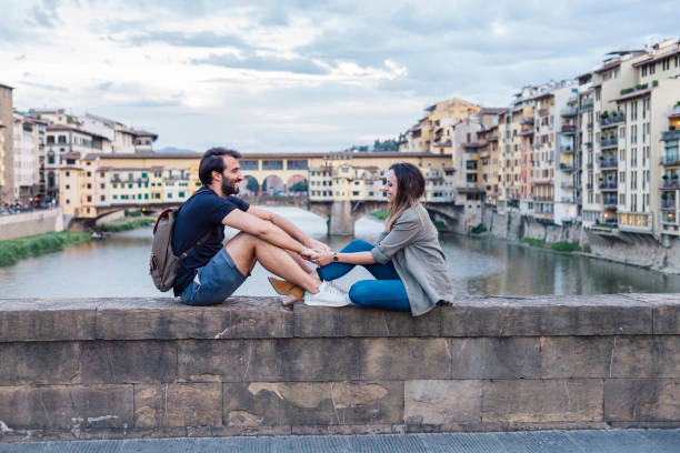 istock Couple at sunset in front of Ponte Vecchio, Florence 933653674