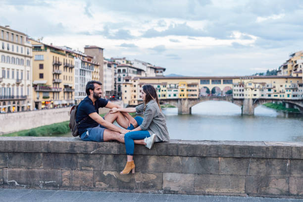 istock Couple at sunset in front of Ponte Vecchio, Florence 933653676