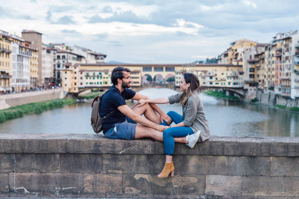 istock Couple at sunset in front of Ponte Vecchio, Florence 933653680
