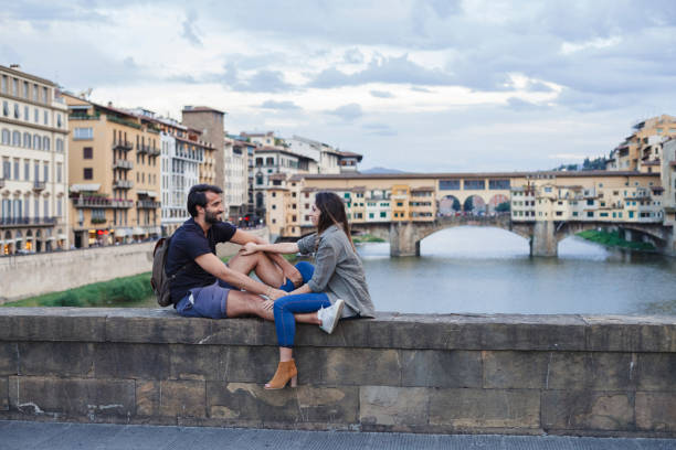 istock Couple at sunset in front of Ponte Vecchio, Florence 933653682