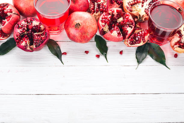 istock Fresh pomegranate juice. Pomegranate. On a white wooden background. Top view. Copy space. 933657866