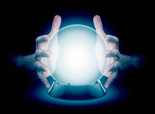 Hands On Crystal Ball And Cryptocurrency A pair of male hands surrounding a crystal ball conjuring up a hologram on an isolated dark studio background crystal ball stock pictures, royalty-free photos & images