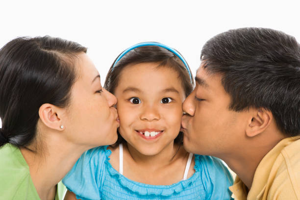 istock Parents kissing daughter. 93366724