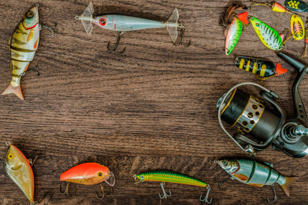 istock Fishing tackle on darken wooden background. Top view. 933670376