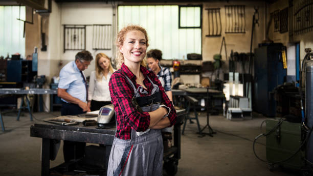 istock Smiling woman in a mechanical workshop 933670788