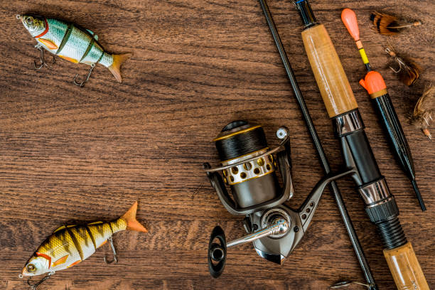 istock Fishing tackle on wooden background. 933670874