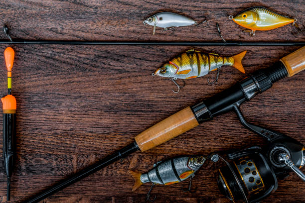 istock Fishing tackle still life on a wooden background. 933671514