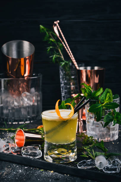 istock Alcohol Cocktail Whiskey Sauer. On a black wooden background. 933678006
