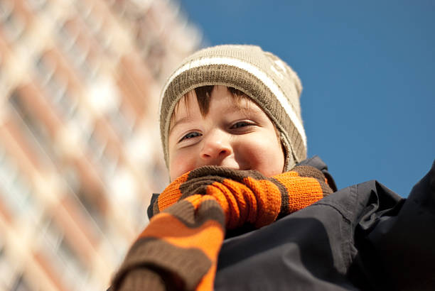 istock smiling boy in a cap and scarf 93367940