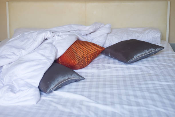 istock Bed sheets and pillows messed up after nights sleep 933694648