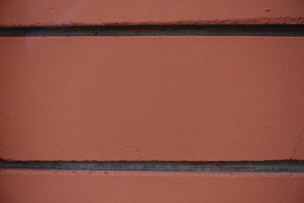Closeup of red bricks with black mortar joints