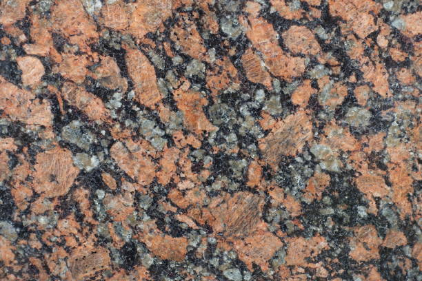 istock Gray, pink and black polished granite stone 933701016