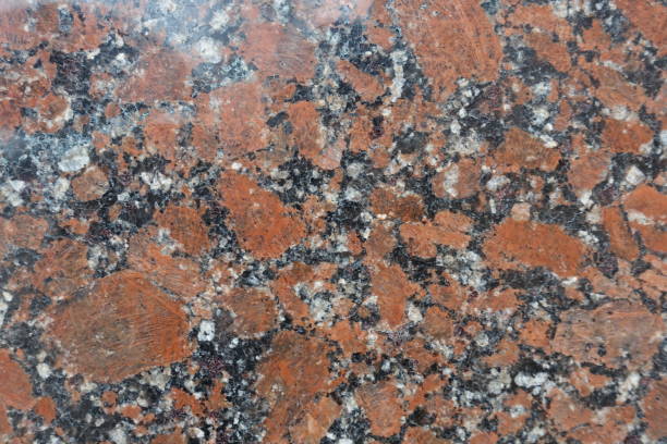 istock Red, black and white polished granite stone 933701032