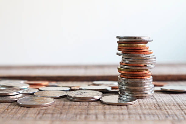 istock Stack of coin on wood plate, finance concept. 933712252