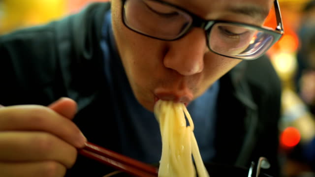 Close-up of Hungry Man eating Noodle Ramen