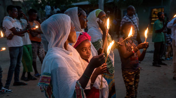 Unidentified Ethiopian people celebrating the Meskel festival in Ethiopia. Turmi, Ethiopia - September 2017: Unidentified Ethiopian people celebrating the Meskel festival in Ehtiopia. Meskel commemorates the finding of the True Cross ethiopian orthodox church stock pictures, royalty-free photos & images