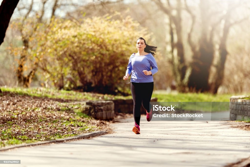 Getting back in shape Young woman running Overweight Stock Photo
