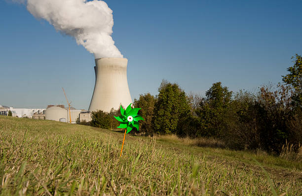 energia verde - wind power toy symbol cooling tower foto e immagini stock