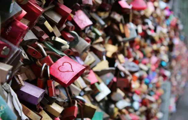 Photo of Valentine's Day - many padlocks on a bridge - red padlock with heart