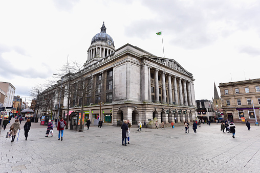 Nottingham, England - May 19, 2018: Nottingham, England - February 25, 2018: Tourists shopping at the Shops on Old Market Square with the Council House during spring.