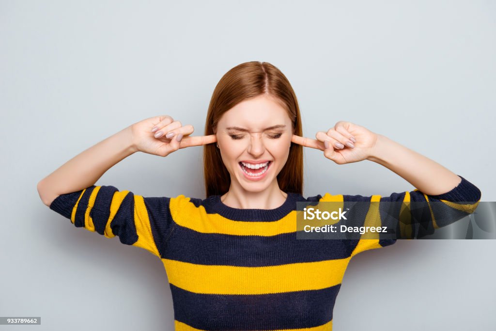 Negative mood pms scream routine failure loser headache struggle concept. Portrait of sad unhappy upset disappointed frustrated shouting exhausted manager closing ears isolated on gray background Noise Stock Photo