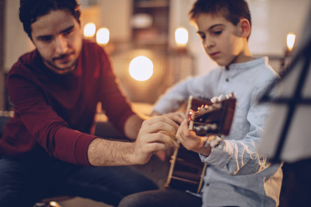 istock Learning to play acoustic guitar 933798584