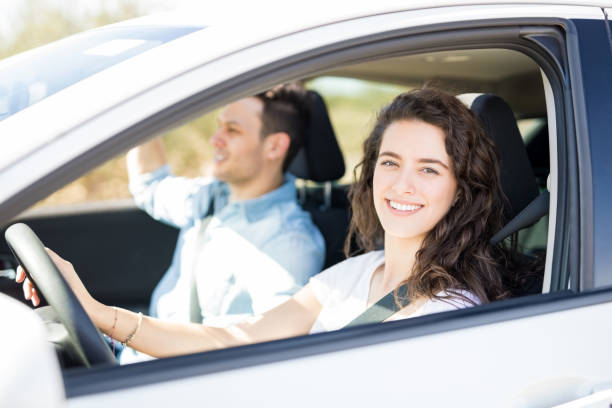 istock Couple driving a car on road trip 933800872
