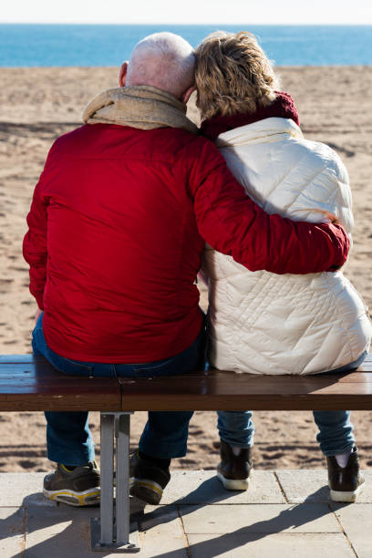 istock Mature couple sitting by sea 933801338