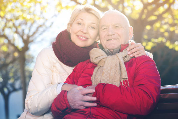 istock Mature couple sitting in park 933801420
