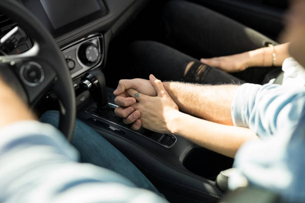 istock Loving couple holding hands in the car 933805138