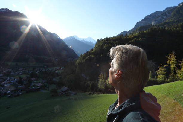 istock Man looks past meadow to mountains 933811742