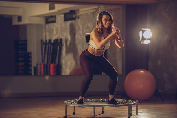 istock Girl exercise on trampoline 933837468