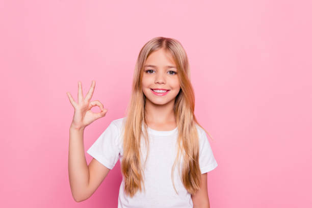istock Elementary dream dreamy perfect excellent studying learning concept. Portrait of cute lovely beautiful adorable sweet with beaming smile in white tshirt girl making ok symbol isolated pink background 933843618