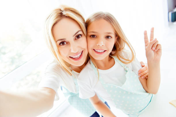 istock Taking making photo memory internet peace support trust care helper blonde hair concept. Close up portrait of excited cheerful cute lovely sweet adorable pretty mom kid looking in camera 933844180