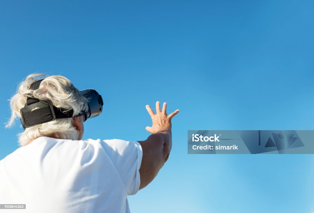 Fri Female is using vr headset outdoors. 360-Degree View Stock Photo
