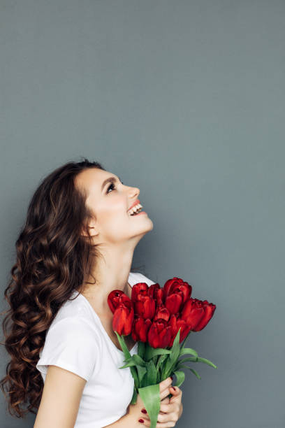 istock Beautiful woman with flowers 933847540