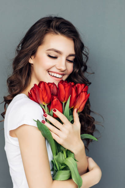 istock Beautiful woman with flowers 933847650