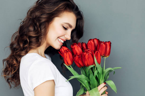 istock Beautiful woman with flowers 933847718