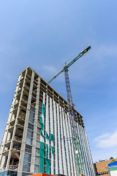 istock Construction of a high-rise building with a crane 933849946