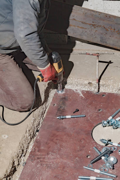istock The builder rotates the nuts with an electric wrench 933850334
