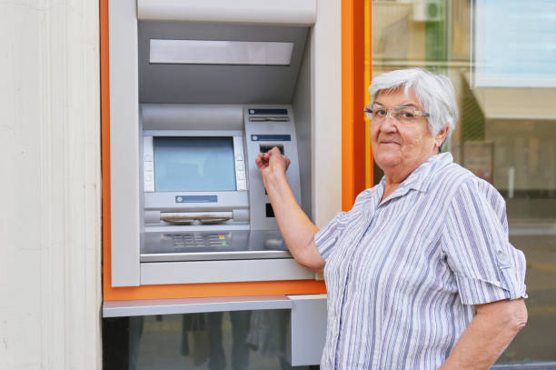 istock Old woman and ATM 933850796