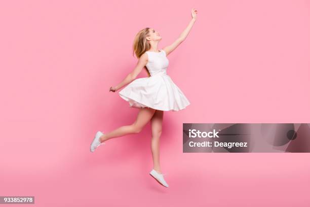 Fullsize Fulllength Side View Portrait Of Beautiful Attractive Carefree Tender Gentle Innocent Stylish Excited Cheerful Girl Jumping Up Wants To Touch Sky Isolated On Background Copyspace Stock Photo - Download Image Now