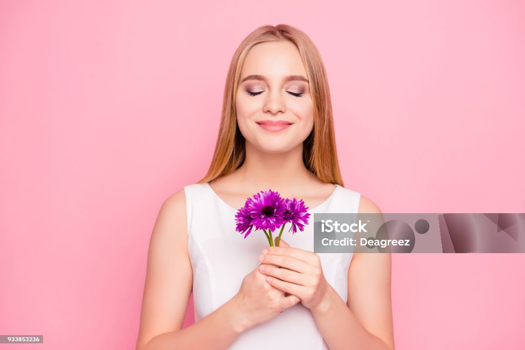 Happiness is in ordinary thinks! Lifestyle stylish trendy white piece calm chill people concept. Portrait of cute relaxed lovely worker enjoying aromatic flowers in hands isolated on pink background Scented Stock Photo