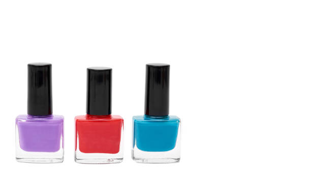 istock colored nail polish bottles isolated on white background. copy space, template 933856348