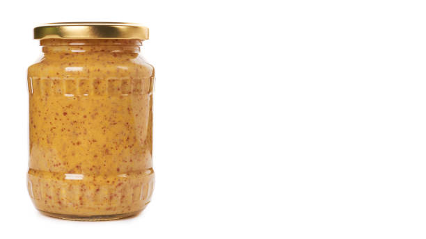 istock home made mustard in glass bottle isolated on white background. copy space, template 933856628