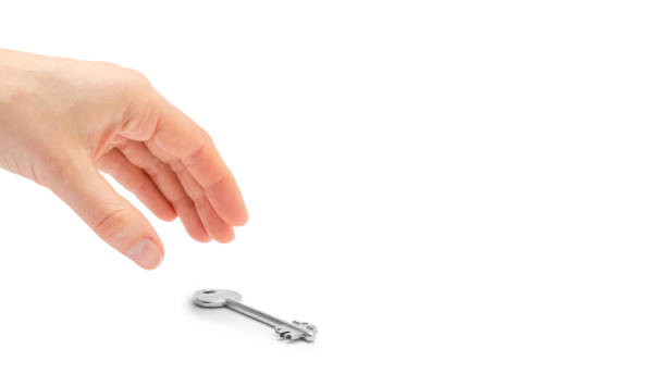 istock female hand takes or gives key. Isolated on white background. copy space, template. 933857064