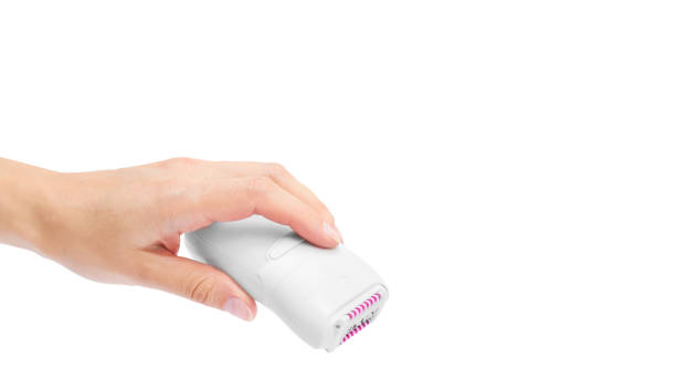 istock Female hand with modern epilator isolated on white background. copy space, template 933857184