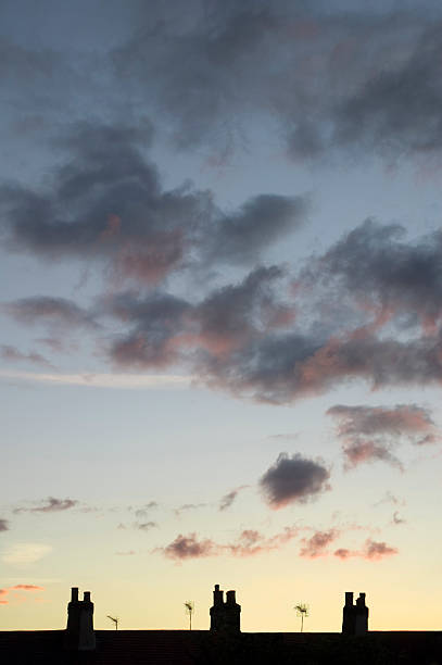 chimney silhouettes at dusk stock photo