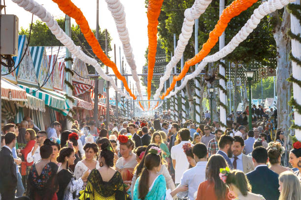 multidão de pessoas de todas as idades se divertindo e tendo a pé para april fair a sevilha. - cultura europeia ocidental - fotografias e filmes do acervo