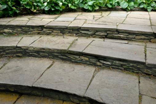 Steps on a large patio made from natural slate.